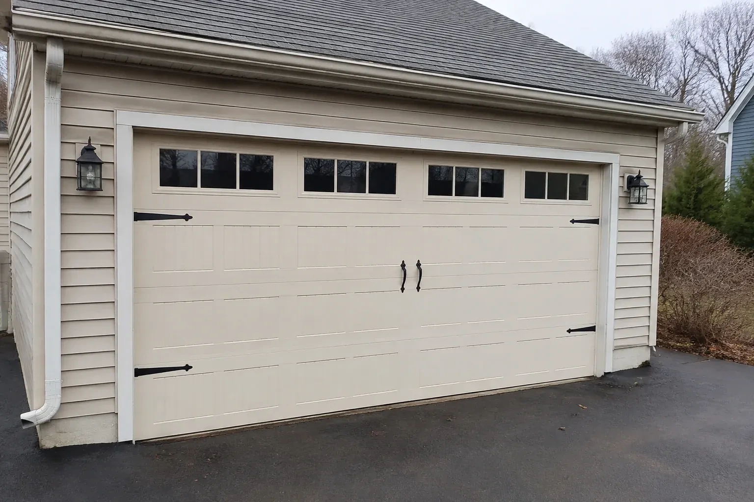 Cream carriage-house-style garage door with dark decorative hardware. — Carriage-House Garage Door Installation, Woolwich